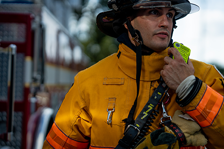 A firefighter in plantation Florida using an APX NEXT XN radio and remote speaker microphone