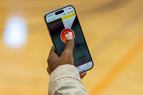 Teacher activating a panic button on their phone.