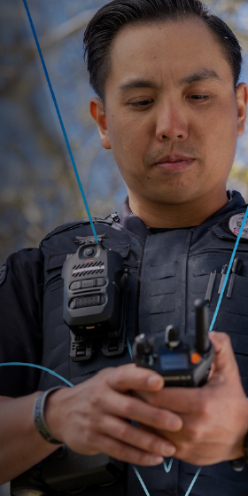 Image of male police officer handling a 2 way radio and advertisement to announce q2 2025 earnings