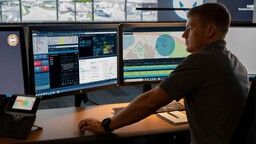 Image of man viewing computer screens with Motorola Solutions' VESTA next generation 911 solution